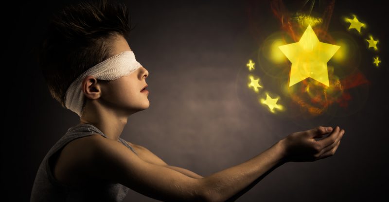 glowing-yellow-stars-over-the-open-hands-of-a-blind-boy-with-bandage-on-his-eyes-against-gray-backgr-369717947-800x416